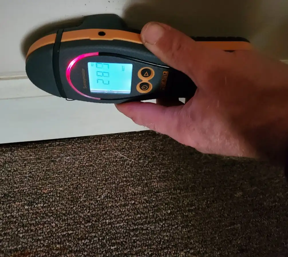 Moisture detection at baseboard during Storm Damage Restoration in Rockdale